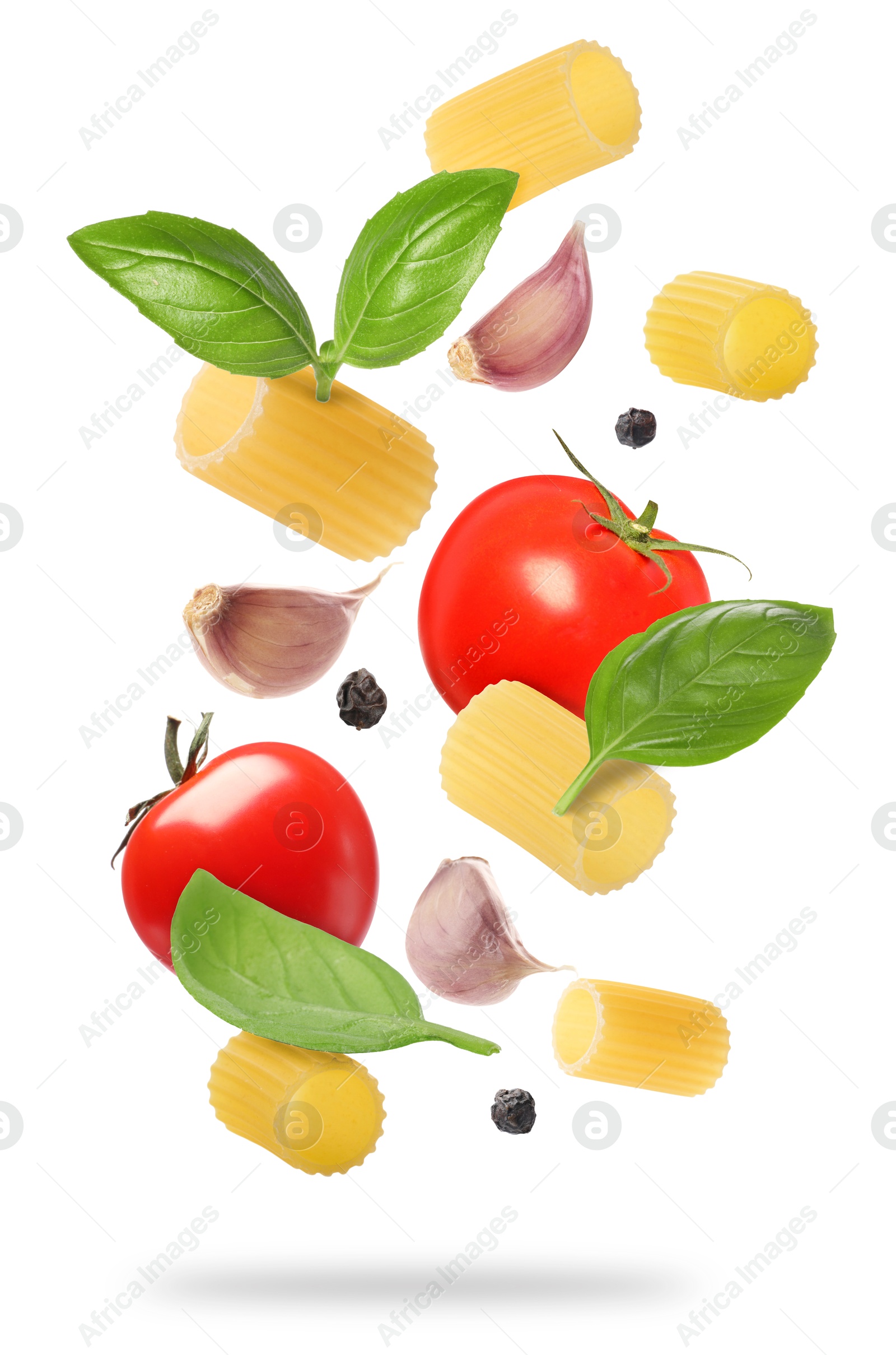 Image of Raw pasta, tomatoes, garlic and basil in air on white background