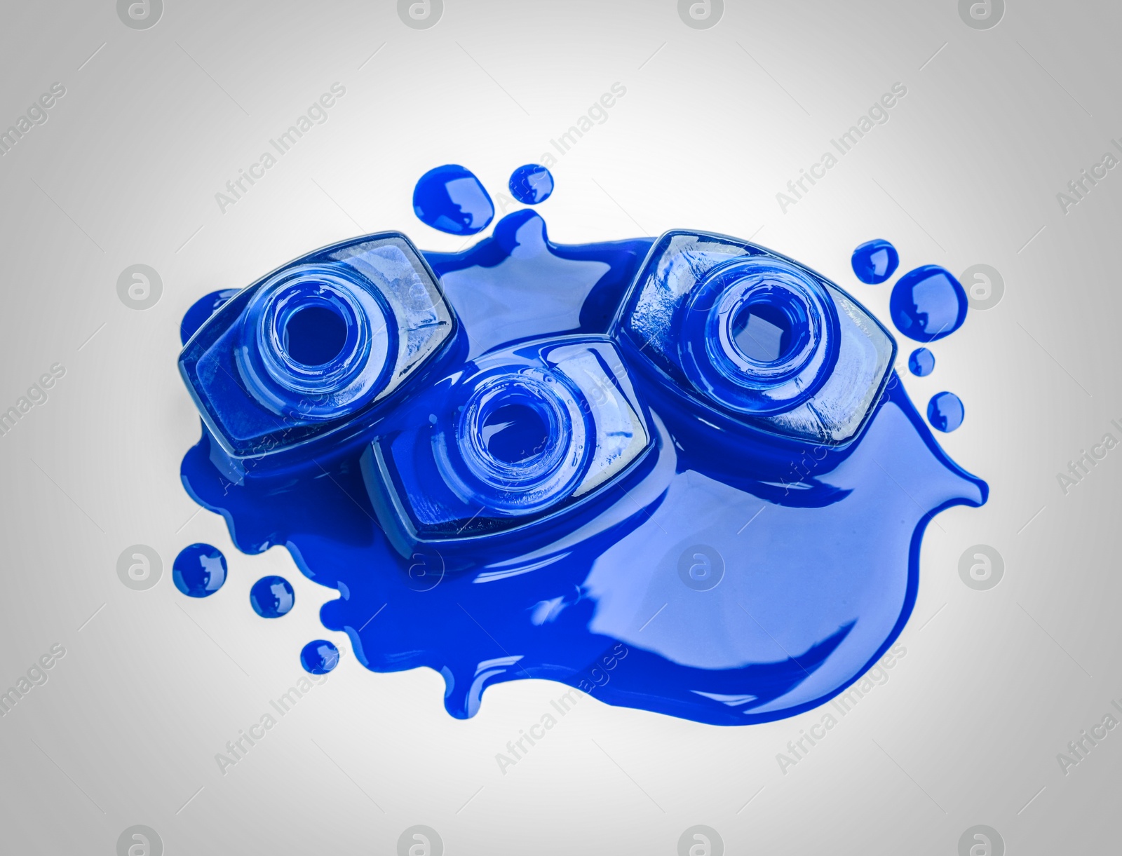 Image of Blue nail polish in bottles on light background, top view