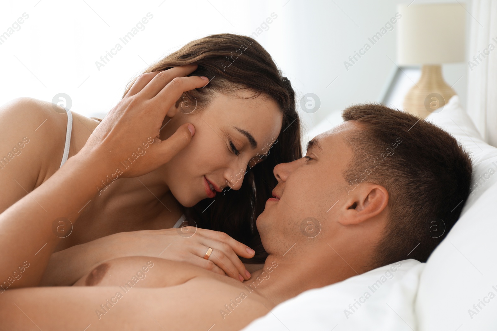 Photo of Lovely couple lying in bed at morning