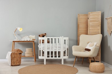 Newborn baby room interior with stylish furniture and comfortable crib
