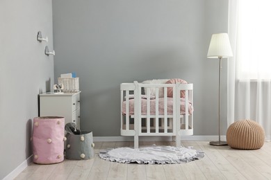 Photo of Newborn baby room interior with stylish furniture and comfortable crib