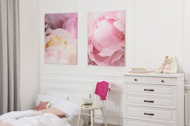 Cute child's room interior with modern furniture and beautiful pictures of on wall