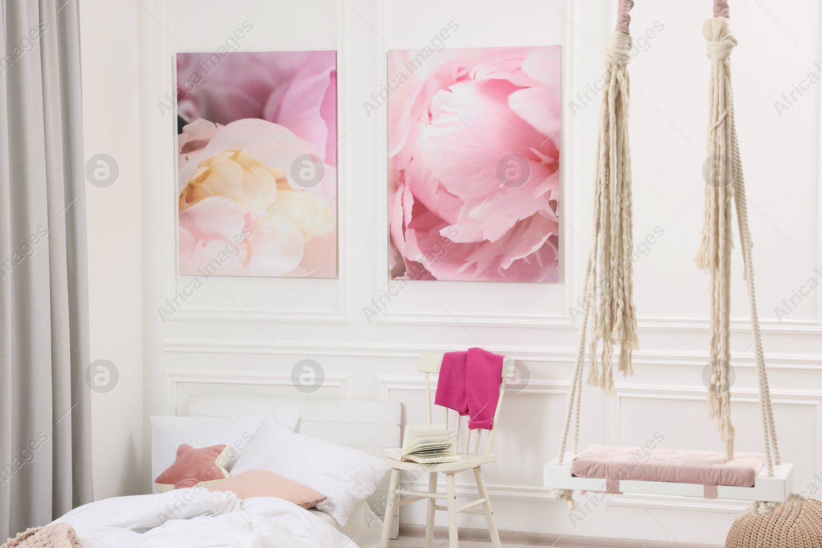 Photo of Cute child's room interior with swing and beautiful pictures of on wall