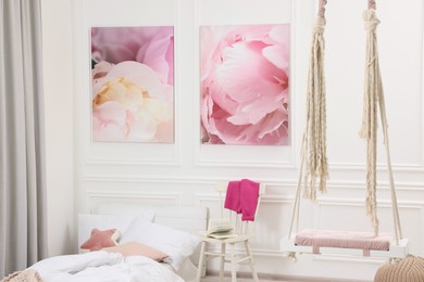 Photo of Cute child's room interior with swing and beautiful pictures of on wall