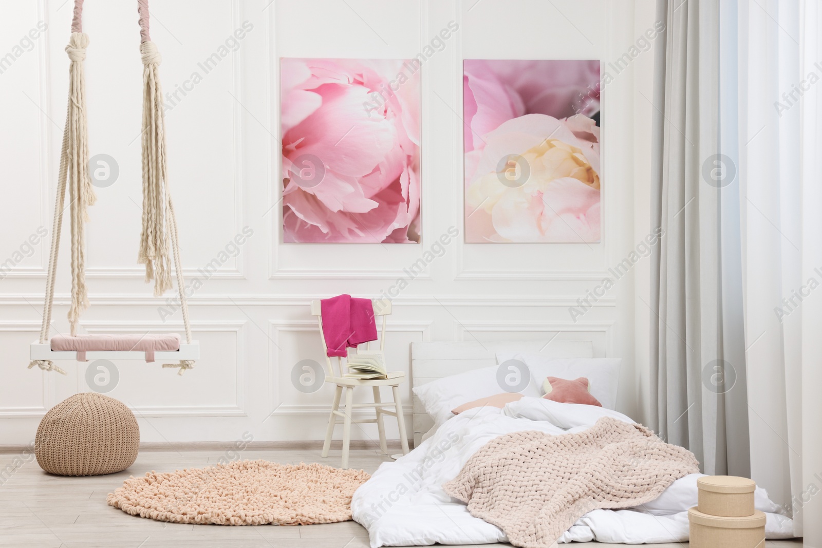 Photo of Cute child's room interior with swing and beautiful pictures of on wall