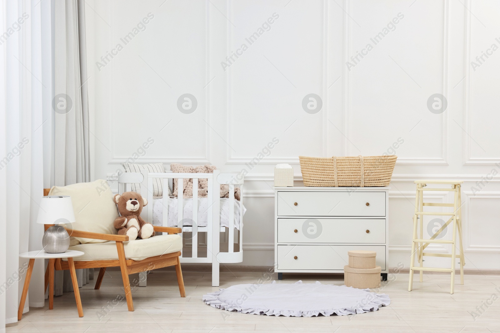 Photo of Newborn baby room interior with stylish furniture and comfortable crib