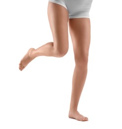 Woman with slim legs on white background, closeup