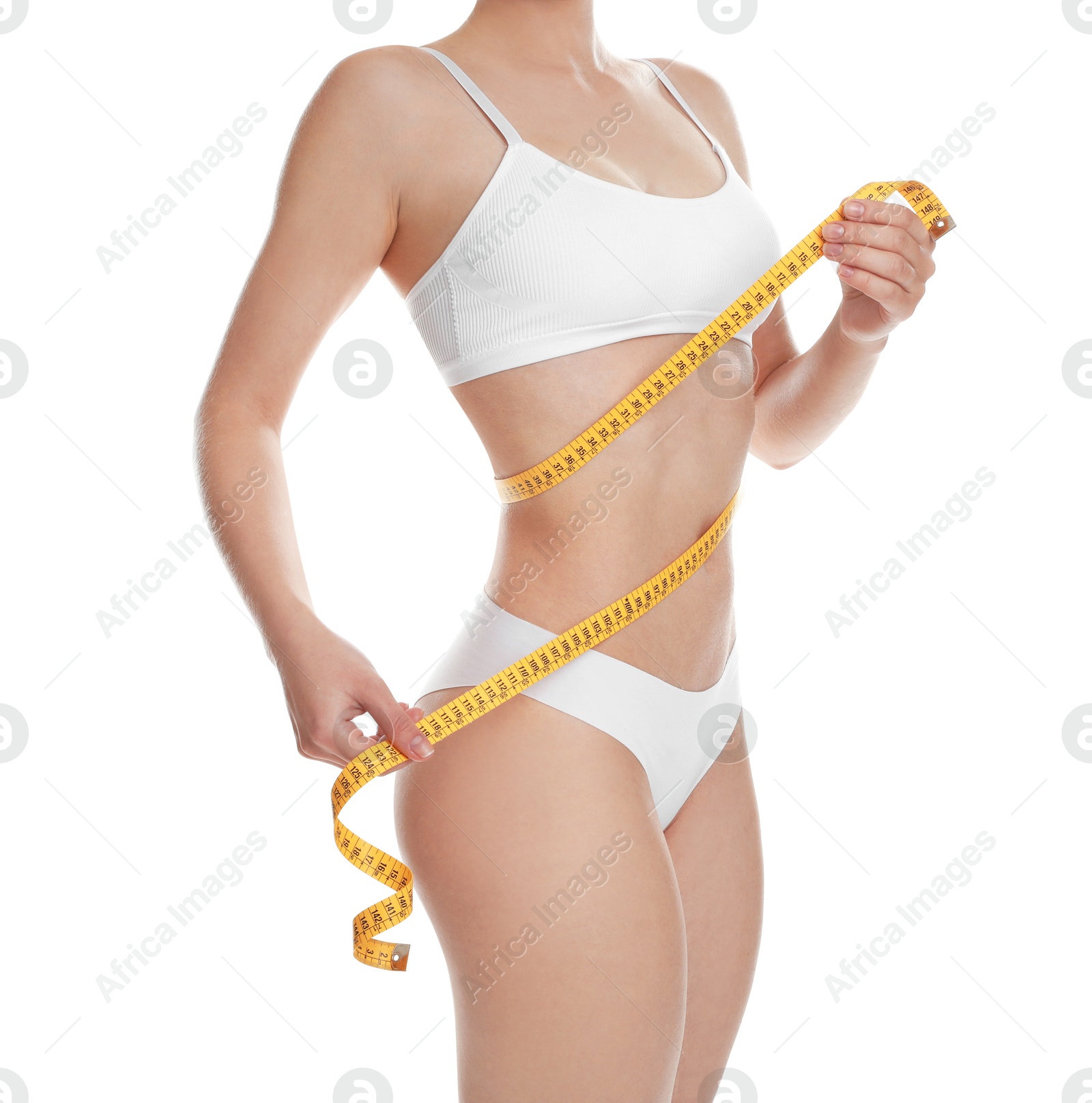 Photo of Woman with measuring tape showing her slim body against white background, closeup