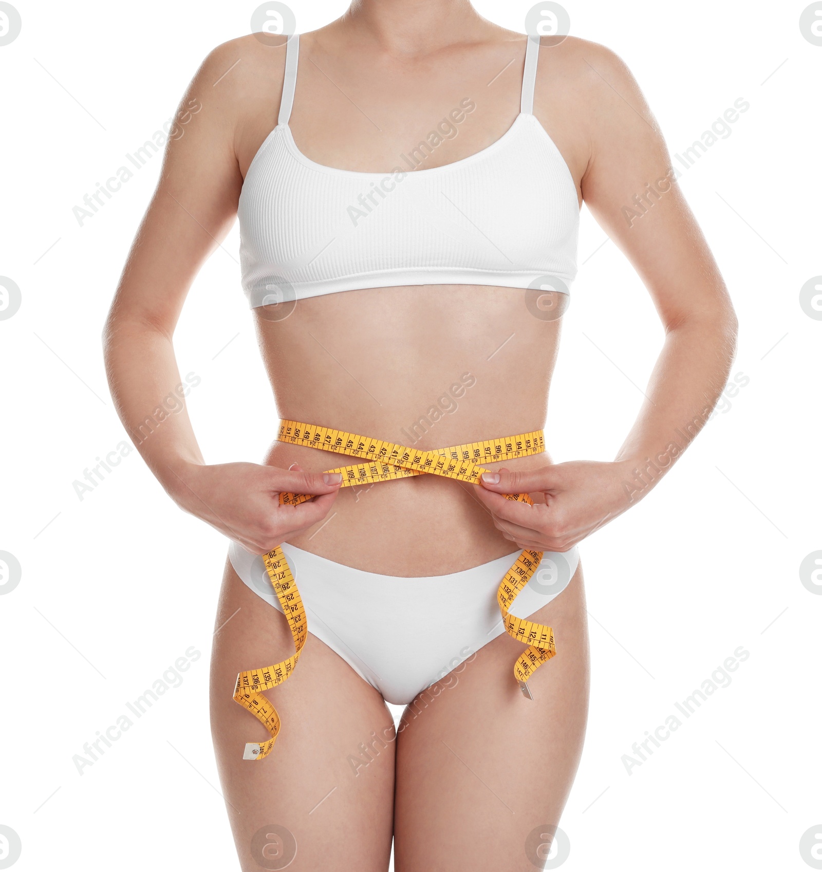 Photo of Woman with measuring tape showing her slim body against white background, closeup