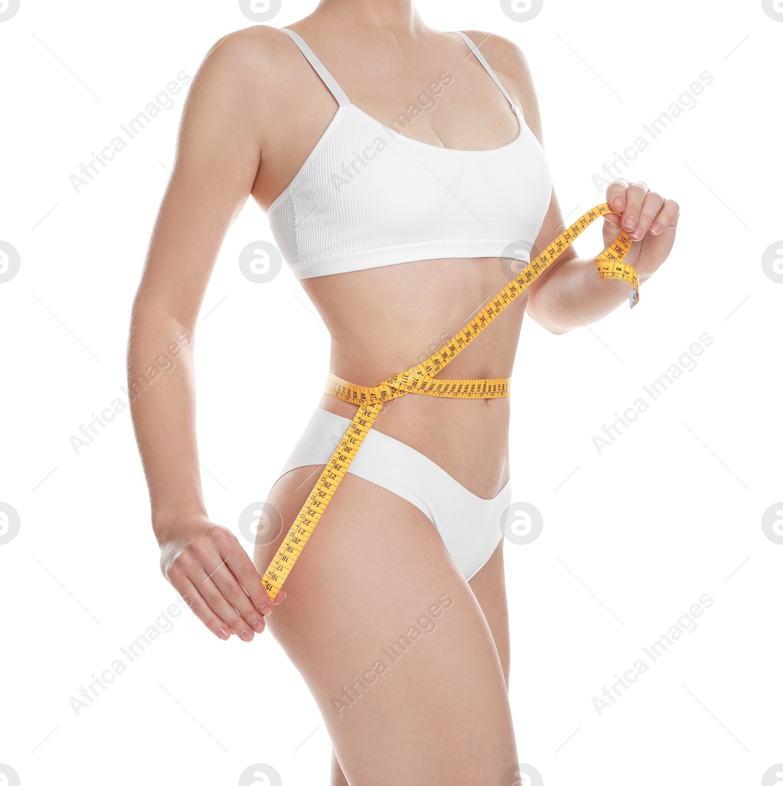 Photo of Woman with measuring tape showing her slim body against white background, closeup