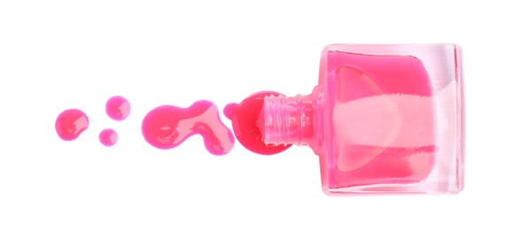 Bottle and spilled pink nail polish isolated on white, top view