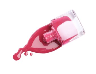 Bottle and spilled pink nail polish isolated on white, top view