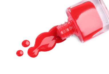 Photo of Bottle and spilled red nail polish isolated on white, top view