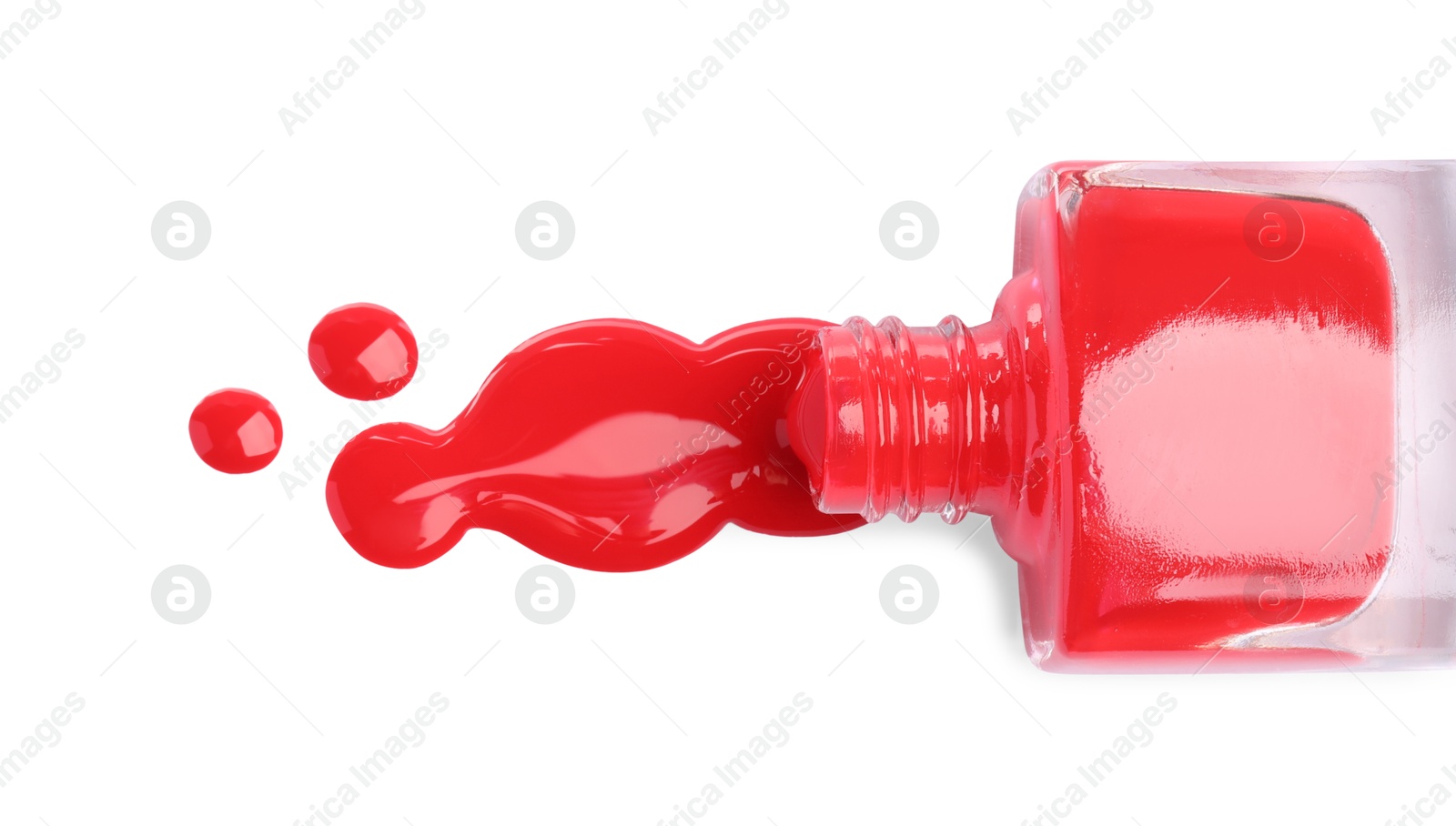 Photo of Bottle and spilled red nail polish isolated on white, top view