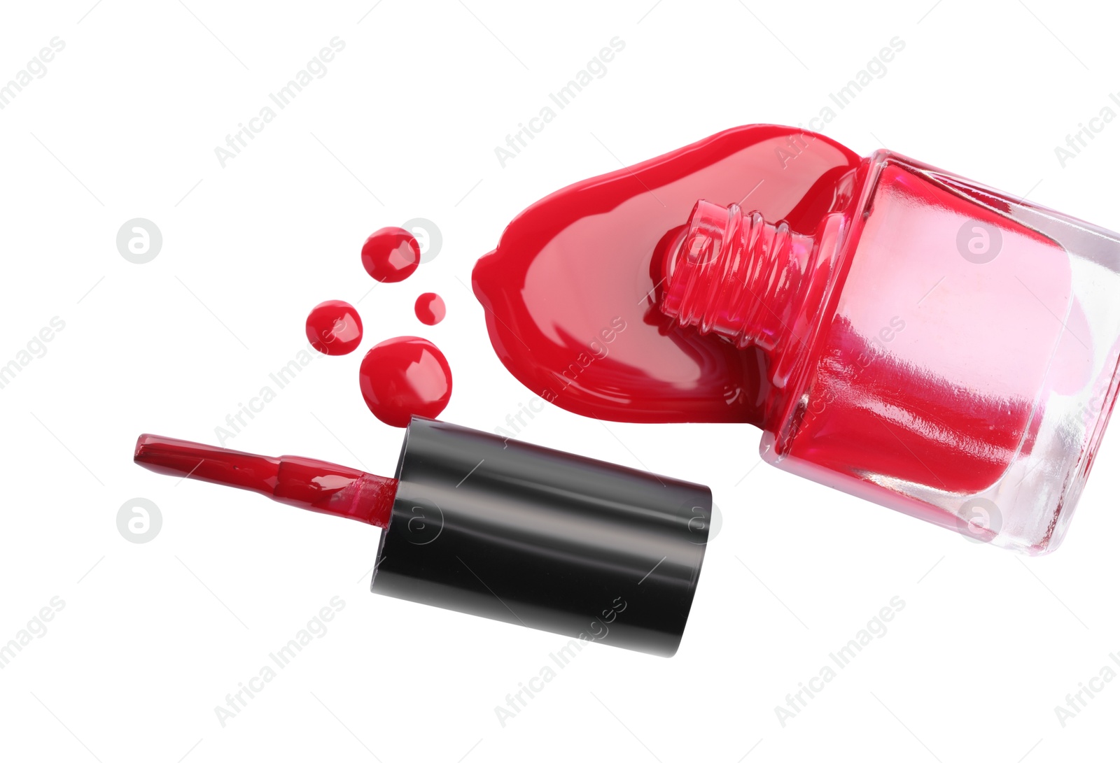 Photo of Bottle and brush with spilled red nail polish isolated on white, top view