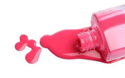 Photo of Bottle and spilled pink nail polish isolated on white, above view