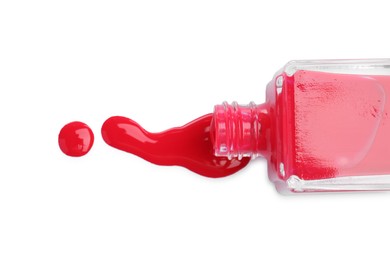 Photo of Overturned bottle of bright nail polish isolated on white, top view