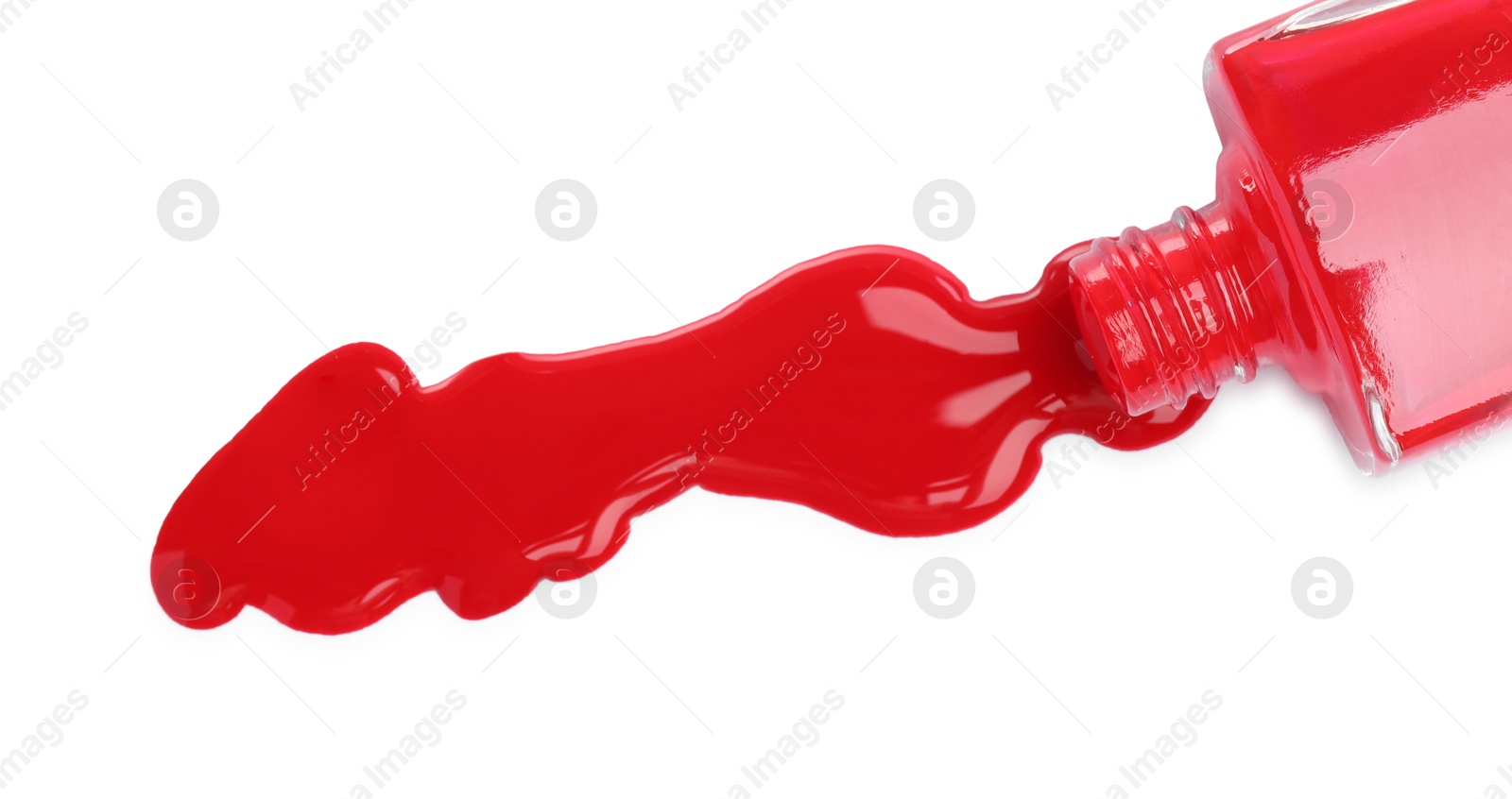 Photo of Overturned bottle of red nail polish isolated on white, top view