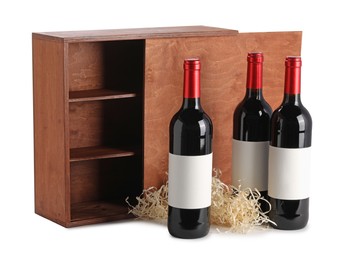 Photo of Wooden gift box with wine bottles isolated on white