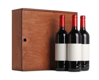 Wooden gift box with wine bottles isolated on white