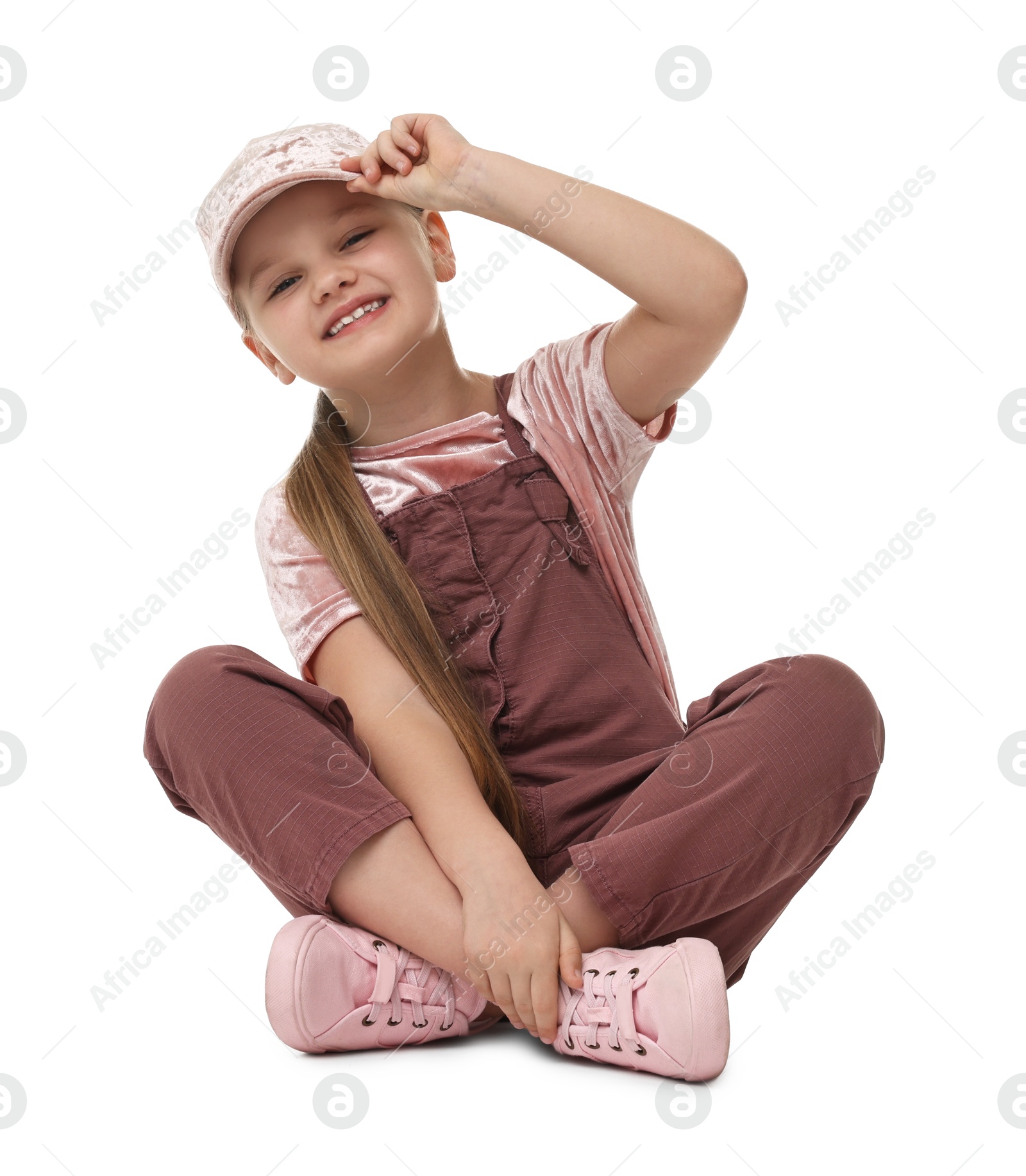 Photo of Cute little dancer sitting on white background