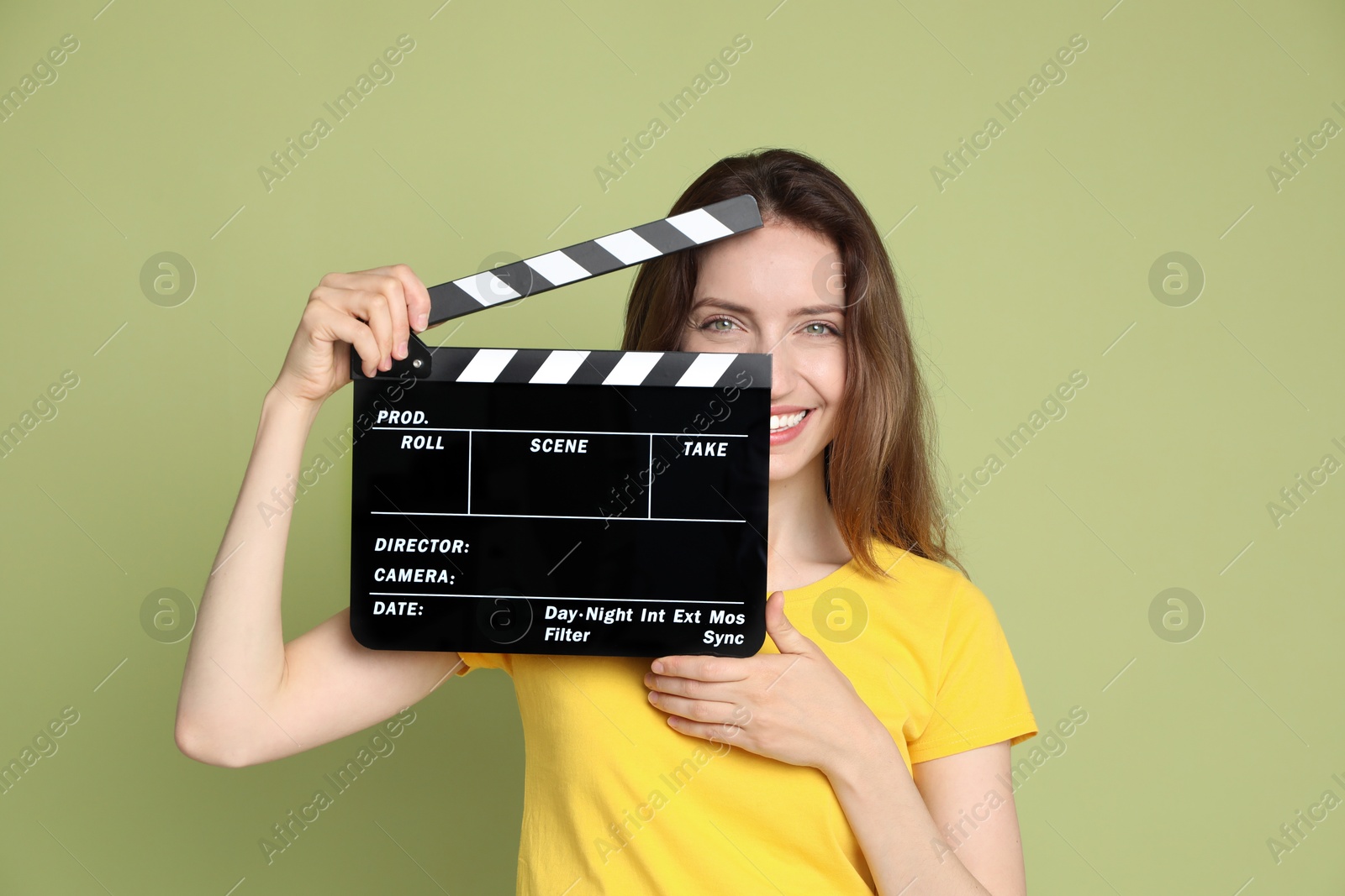 Photo of Making movie. Smiling woman with clapperboard on green background