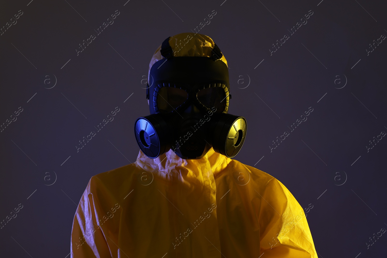 Photo of Worker in gas mask on dark background