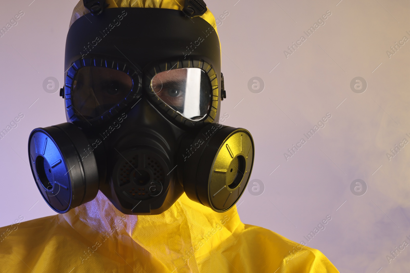 Photo of Worker in gas mask on light background, closeup. Space for text
