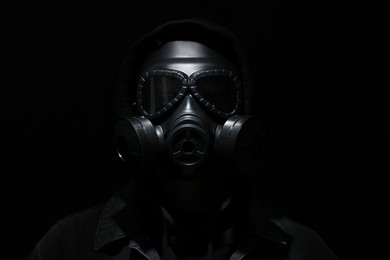 Photo of Man in gas mask on black background
