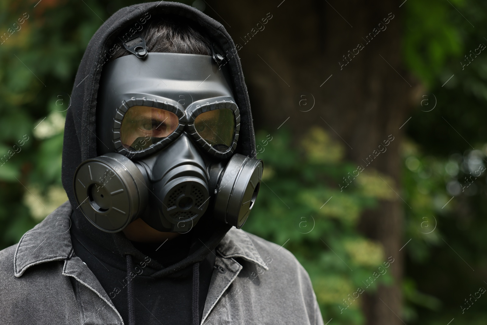 Photo of Man in gas mask outdoors. Space for text