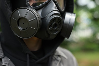 Man in black gas mask outdoors, closeup