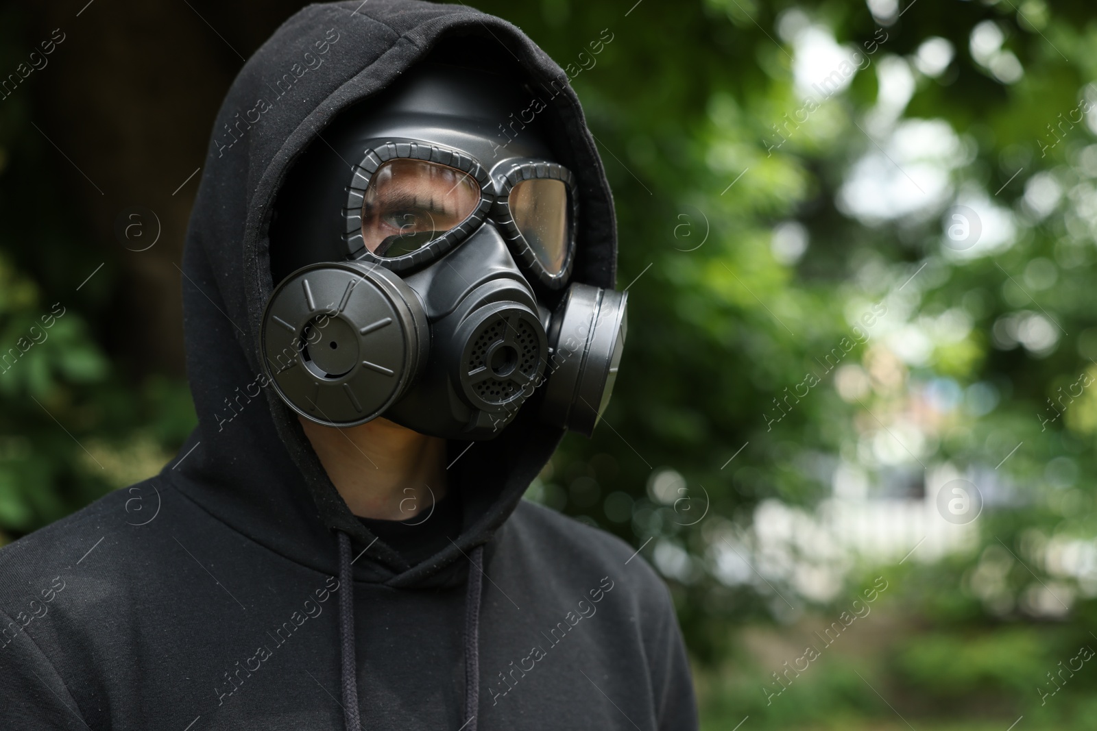 Photo of Man in gas mask outdoors. Space for text