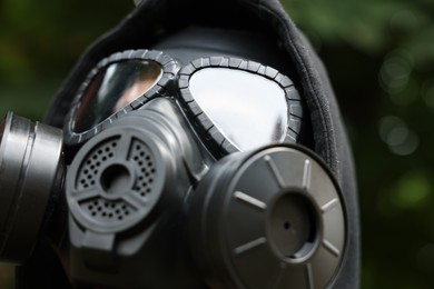 Man in black gas mask outdoors, closeup