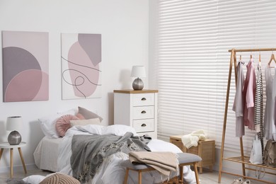 Photo of Teen's room interior with modern furniture and beautiful pictures on wall