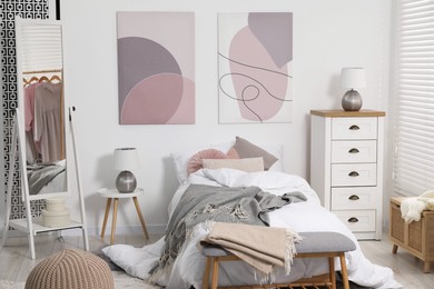 Teen's room interior with modern furniture and beautiful pictures on wall