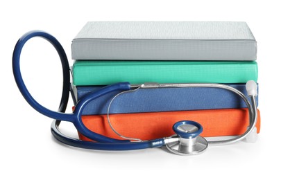 Photo of Stethoscope and stack of books isolated on white