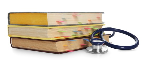 Photo of Stethoscope and stack of books isolated on white