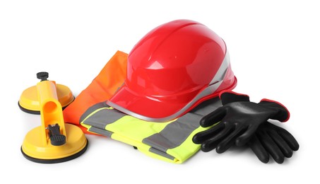 Photo of Hard hat, protective gloves, glass suction cups and reflective vest isolated on white