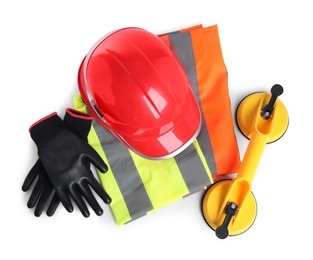 Photo of Hard hat, protective gloves, glass suction cups and reflective vest isolated on white, top view