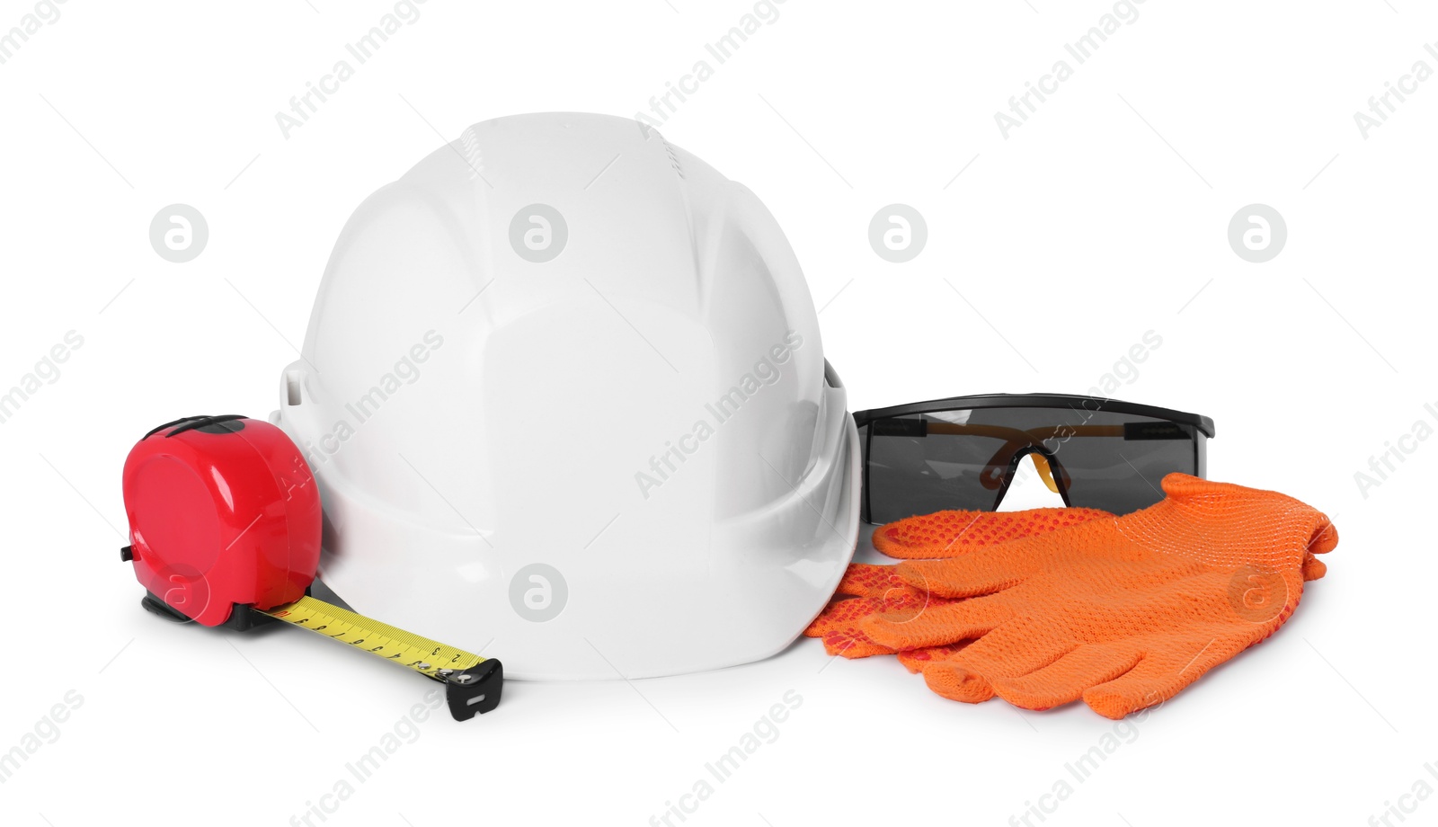 Photo of Hard hat, goggles, tape measure and protective gloves isolated on white