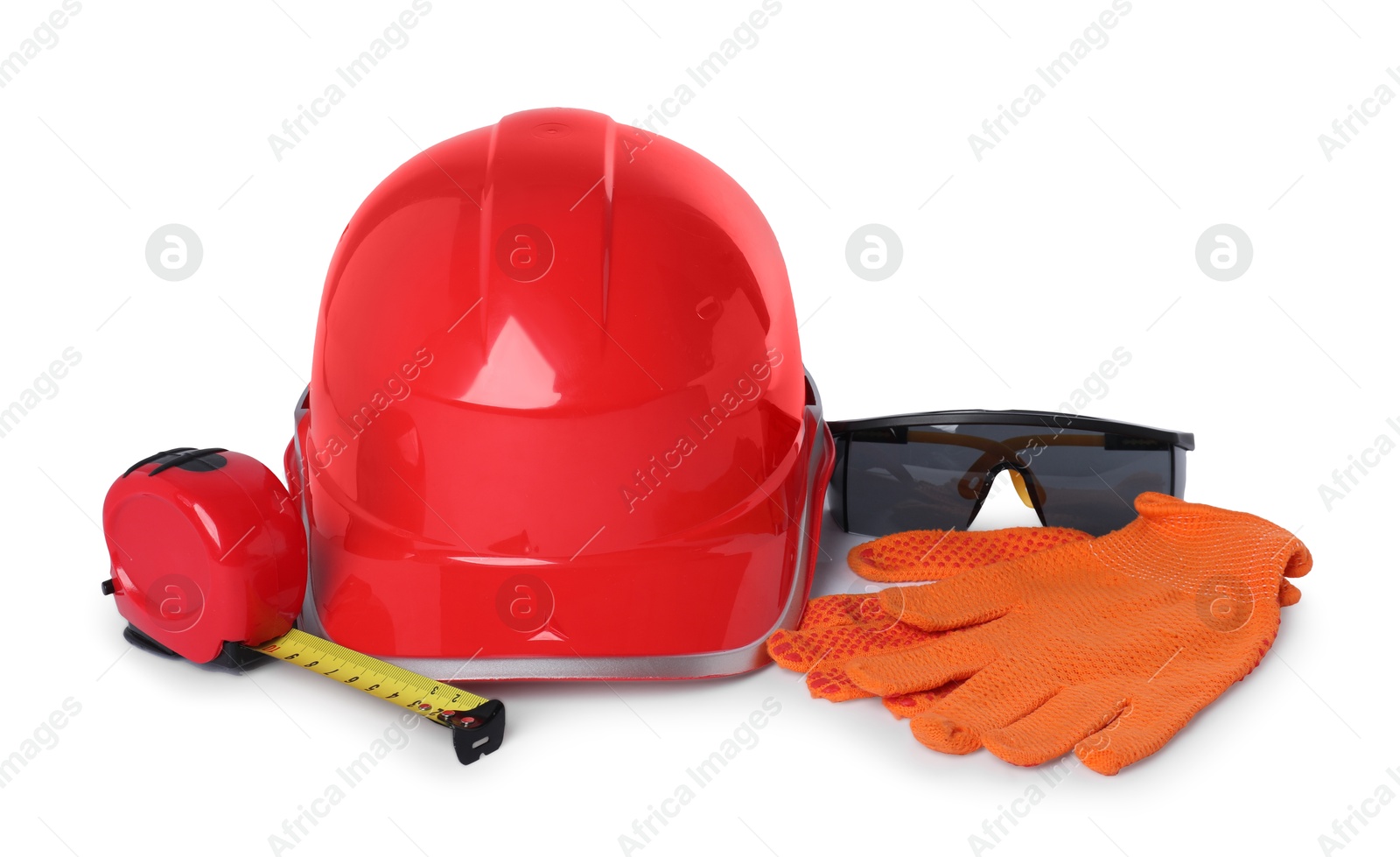 Photo of Hard hat, goggles, tape measure and protective gloves isolated on white