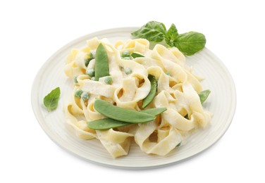 Delicious pasta with green peas and creamy sauce isolated on white