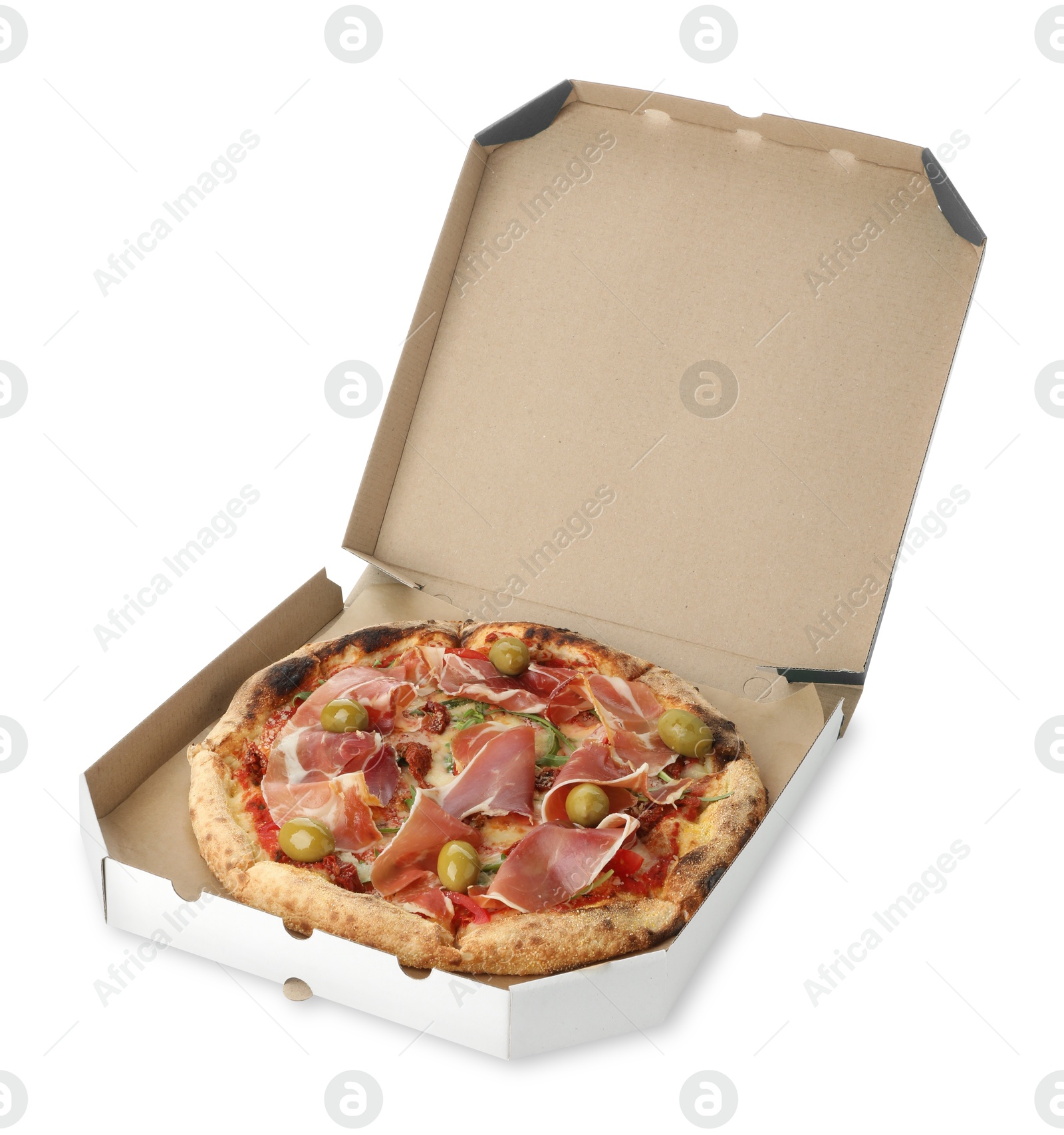 Photo of Tasty pizza with cured ham, olives and sun-dried tomato in cardboard box isolated on white