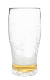 Photo of Almost empty glass of beer isolated on white