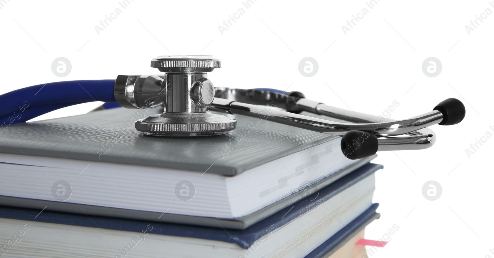 Photo of Stethoscope on stack of books against white background