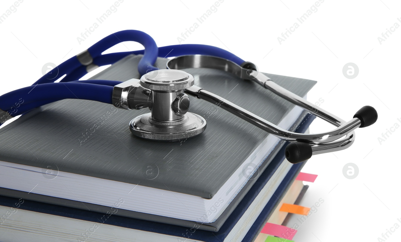 Photo of Stethoscope on stack of books against white background