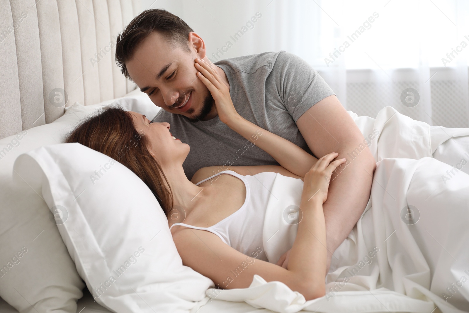 Photo of Lovely couple enjoying time together in bed at morning