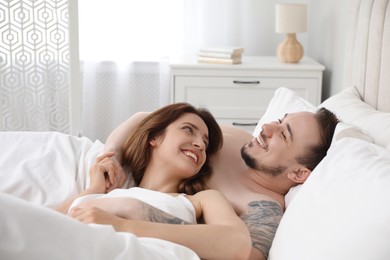 Photo of Lovely couple enjoying time together in bed at morning