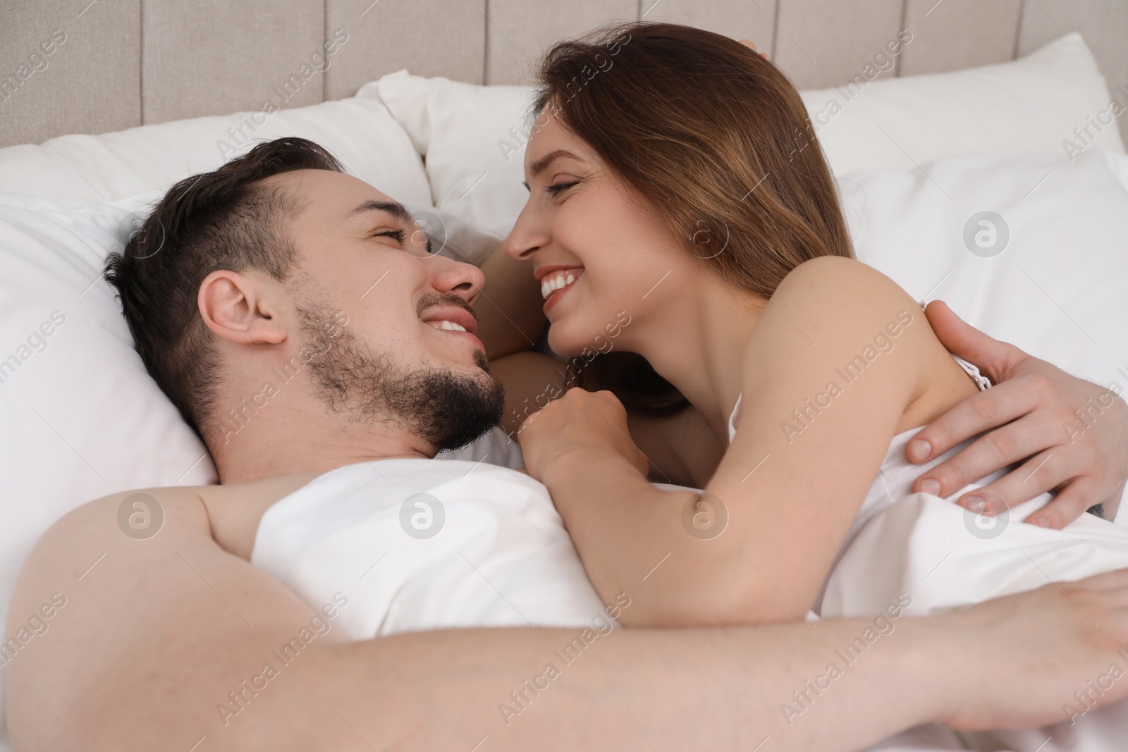 Photo of Lovely couple enjoying time together in bed at morning