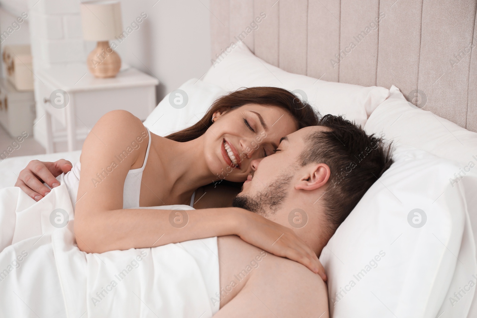 Photo of Lovely couple enjoying time together in bed at morning